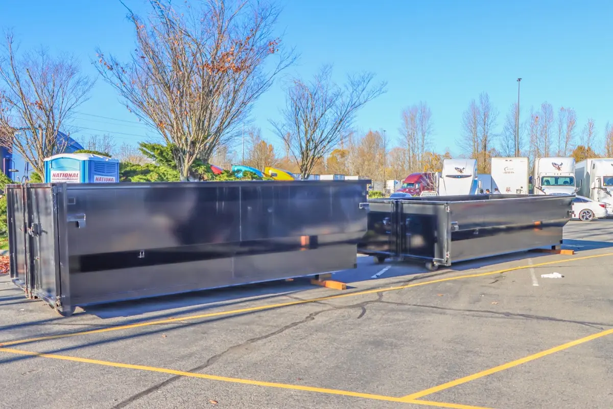 Professional dumpster rental service with roll-off container on residential driveway in Lake Dallas